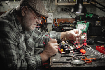 Technician repairing a computer in a workshop. Selective focus.