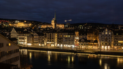 Nighttime View of Historic City Center with Illuminated Cathedral and Buildings in Zurich