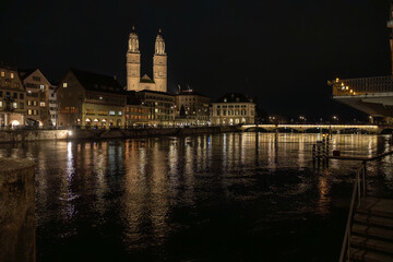Nighttime View of Historic City Center with Illuminated Cathedral and Buildings in Zurich