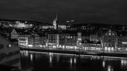 Nighttime View of Historic City Center with Illuminated Cathedral and Buildings in Zurich