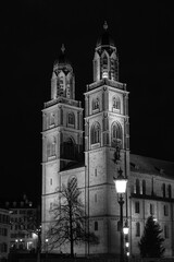 Nighttime View of Historic City Center with Illuminated Cathedral and Buildings in Zurich