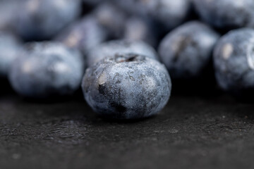 a pile of blueberries scattered on the board