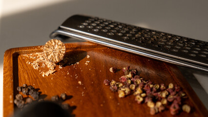 Variety of dried spices assorted on a rustic wooden plate