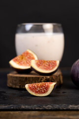 sweet fig fruits and a glass of yogurt with flavors and pieces of figs