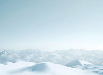 Fototapeta premium Serene Winter Mountainscape: A Panoramic View of Snow-Covered Peaks Under a Pale Sky