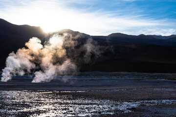 Sunrise light through vapor steamer in El Tatio
