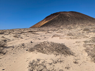Dunes on the way to La Cocina beach and Montana a Amarilla volcano, La Graciosa Island, Canary islands, Spain