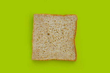 Whole wheat bread  isolated on green background.