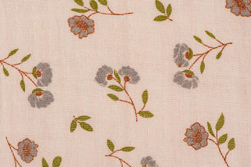 The fabric is light beige with gray flowers painted on it and green petals.