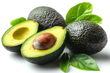 Ripe avocados cut in half with leaves isolated on white.