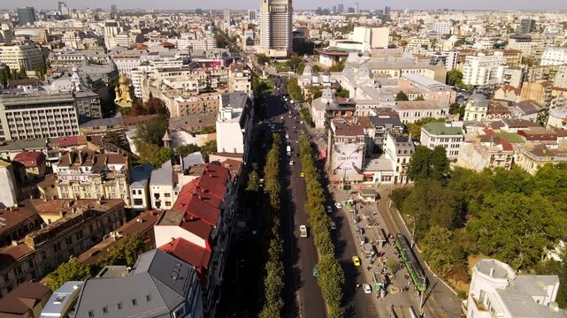 Aerial Shot Of Cars Moving On Roads Amidst Buildings In Residential City, Drone Flying Forward On Sunny Day - Bucharest, Romania