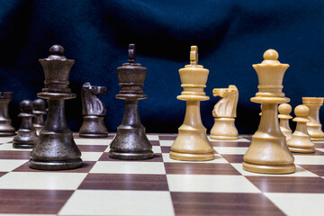 Chessmen photographed on a chessboard with a dark background
