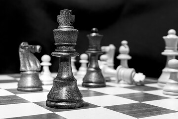Chessmen photographed on a chessboard with a dark background
