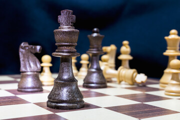 Chessmen photographed on a chessboard with a dark background
