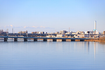 Fototapeta premium Osaka Urban Skyline with Train Bridge and Water Reflections at Early Morning