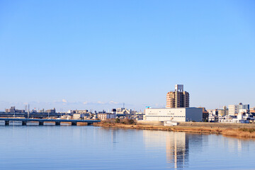 Obraz premium Calm River Scene with Distant City Skyline, Osaka, Japan