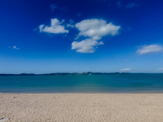 Pacific blue ocean under a summer sky in New Zealand.