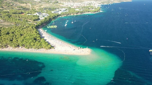 Aerial video of Zlatni Rat beach in Bol, Croatia, focusing on the beach. The video captures the lively summer vibe and iconic scenery of Bol on Brac Island.