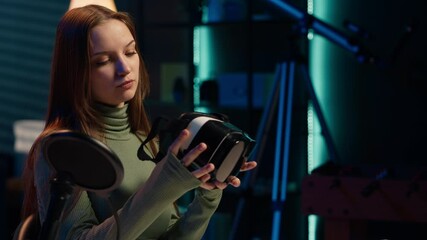 Tech specialist filming sponsored content, unboxing newly released VR glasses product to make fans buy it. Entertainer amazed by product, presenting virtual reality headset to subscribers, camera A