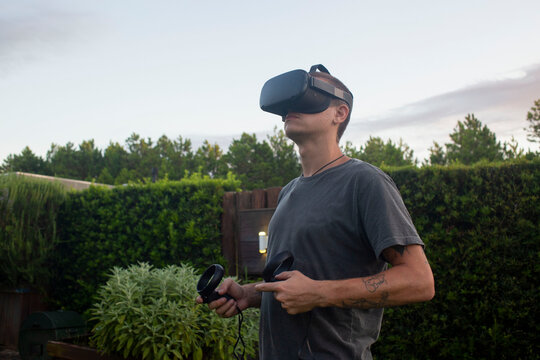 Man using virtual reality glasses outdoors