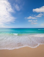 Fototapeta premium Serene beach scene: Soft waves on tranquil turquoise water under a bright blue sky.