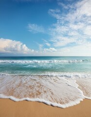 Serene beach scene with gentle waves lapping the shore under a bright blue sky.