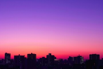 Fototapeta premium A vibrant urban sunset silhouetting city buildings against a gradient sky.