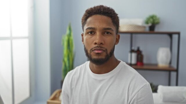 Young man in a wellness spa room looking thoughtful with a modern interior setup