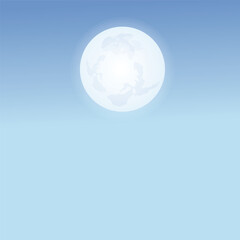 Full moon in a pale blue sky.