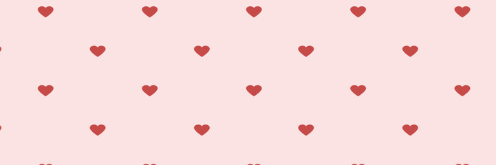 Seamless pattern of red hearts on a pink background.