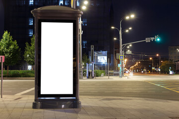 Vertical high billboard in the night city. Near the crossroads. Mock-up.