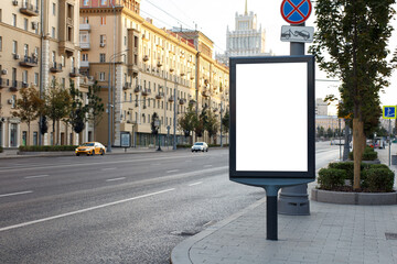 Vertical billboard advertising in the city. Central street comes to life after a dream. Mock-up.