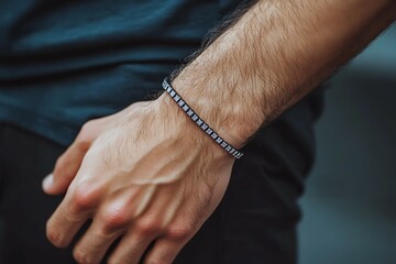 Close up of a man's hand with a bracelet on his wrist