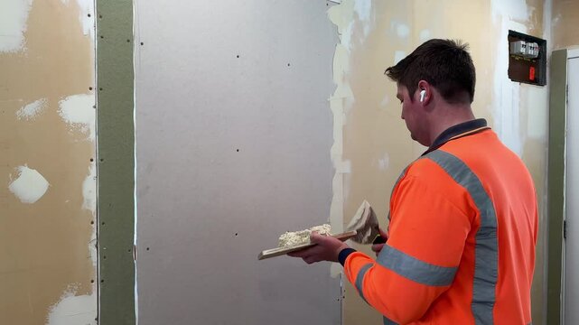 plastering, gib stopping, dry wall, gypsum, plasterer, tradesman, diy, repair, maintenance, preparation, project, renovation, remodel, earbuds, builder, painter, labourer, caucasian, male, orange, ele