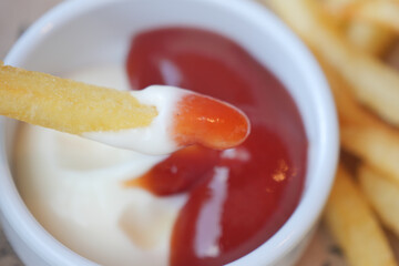 Fries served with Ketchup and a Creamy Dip are beautifully in Focus