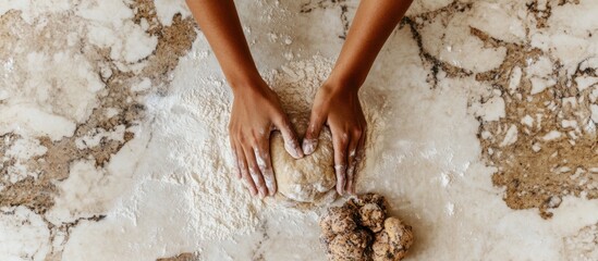 Fototapeta premium Hands kneading dough on marble countertop.