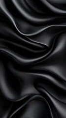 Close-up of black satin-like fabric with smooth, flowing curves, showing light reflections on the surface