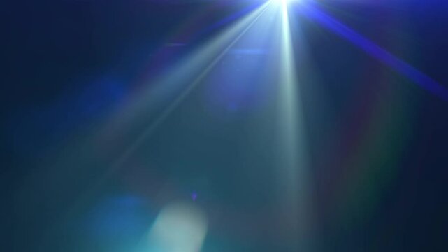 Loop blue optical lens flares shine rays light move from top left to top right on black abstract background. 4K beautiful blue spotlight effects moving top right. flash lights.Bright light lens flare