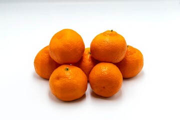 Fresh, ripe tangerines on a white background.