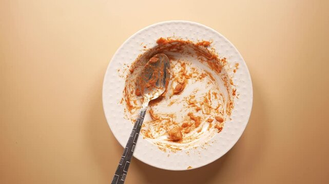 An empty dirty plate with a fork.