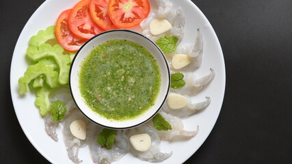 shrimp in fish sauce with Thai spicy seafood dipping sauce on white plate