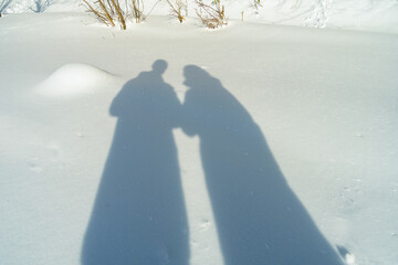 Shadows of a couple on the snow