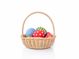 Painted easter eggs in the basket on white background.