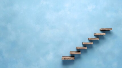 Wooden steps ascending a blue wall, growth concept, background copy space, business success
