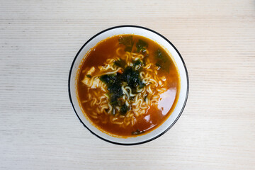 A bowl of spicy noodles soup.