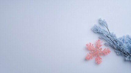 Fototapeta premium Pink Snowflake Frosty Branches on Light Blue Background Winter Holiday Decor