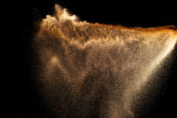Sand flying explosion isolated on black background ,throwing freeze stop motion object design.