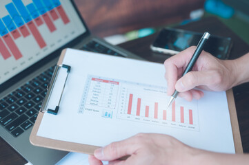 Businessman analyst data on clipboard use computer and dashboard for data analysis Data Management...