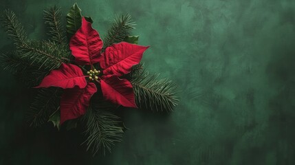 A festive arrangement featuring a vibrant red poinsettia flower at the center,