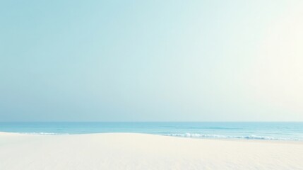 Obraz premium Serene Coastal Scene Soft Sand Meets Tranquil Ocean Under a Pale Sky